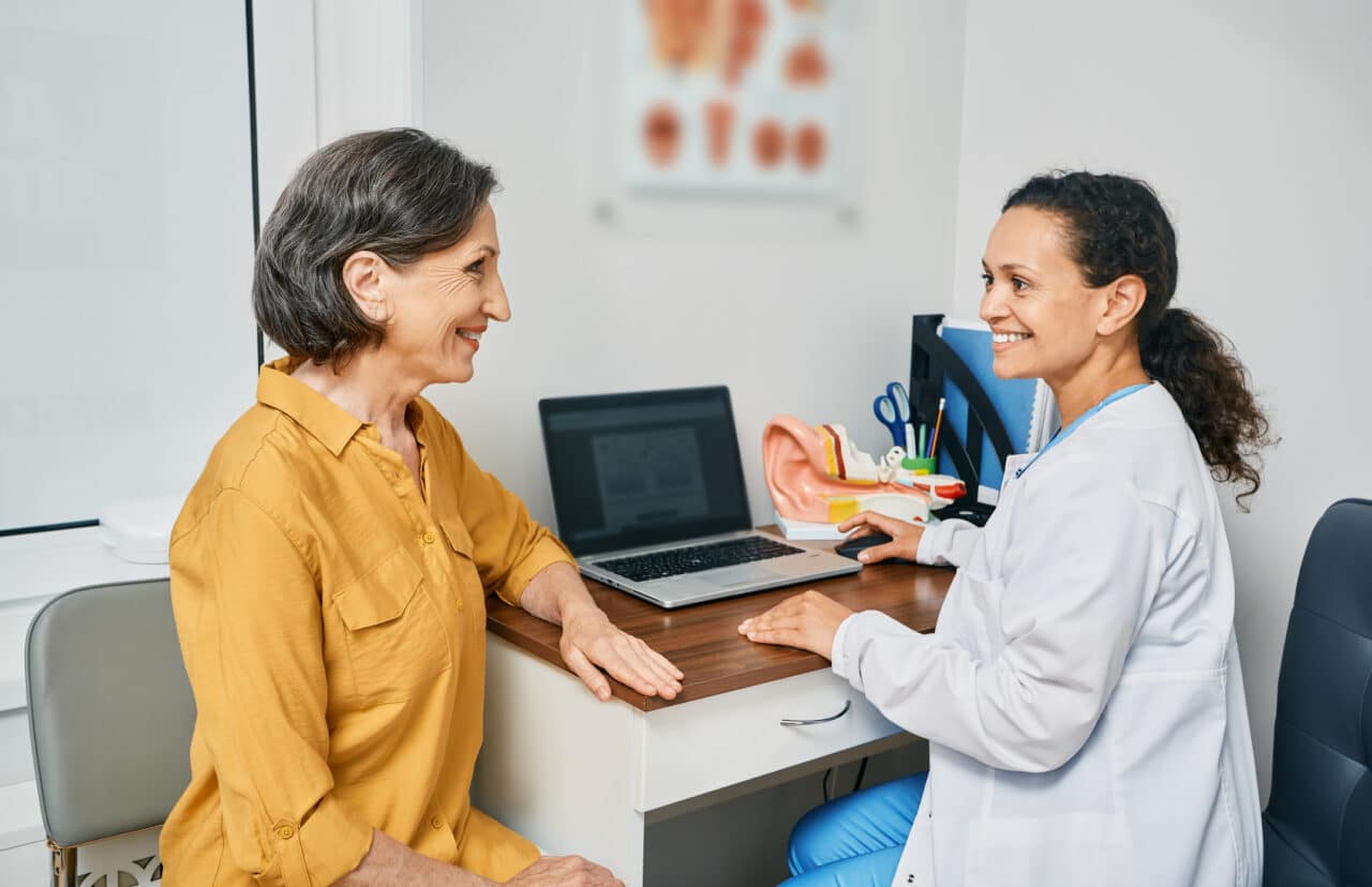 Senior woman having a consultation with an audiologist.