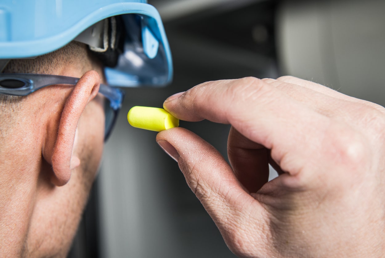 Worker places earplug