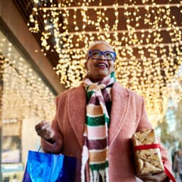 Senior woman carrying presents at the shopping center