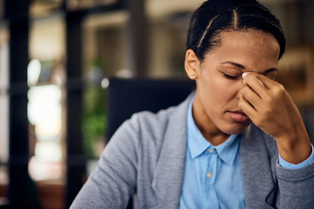 Woman with nose pain holding her nose