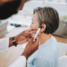 Doctor examining a woman's ear